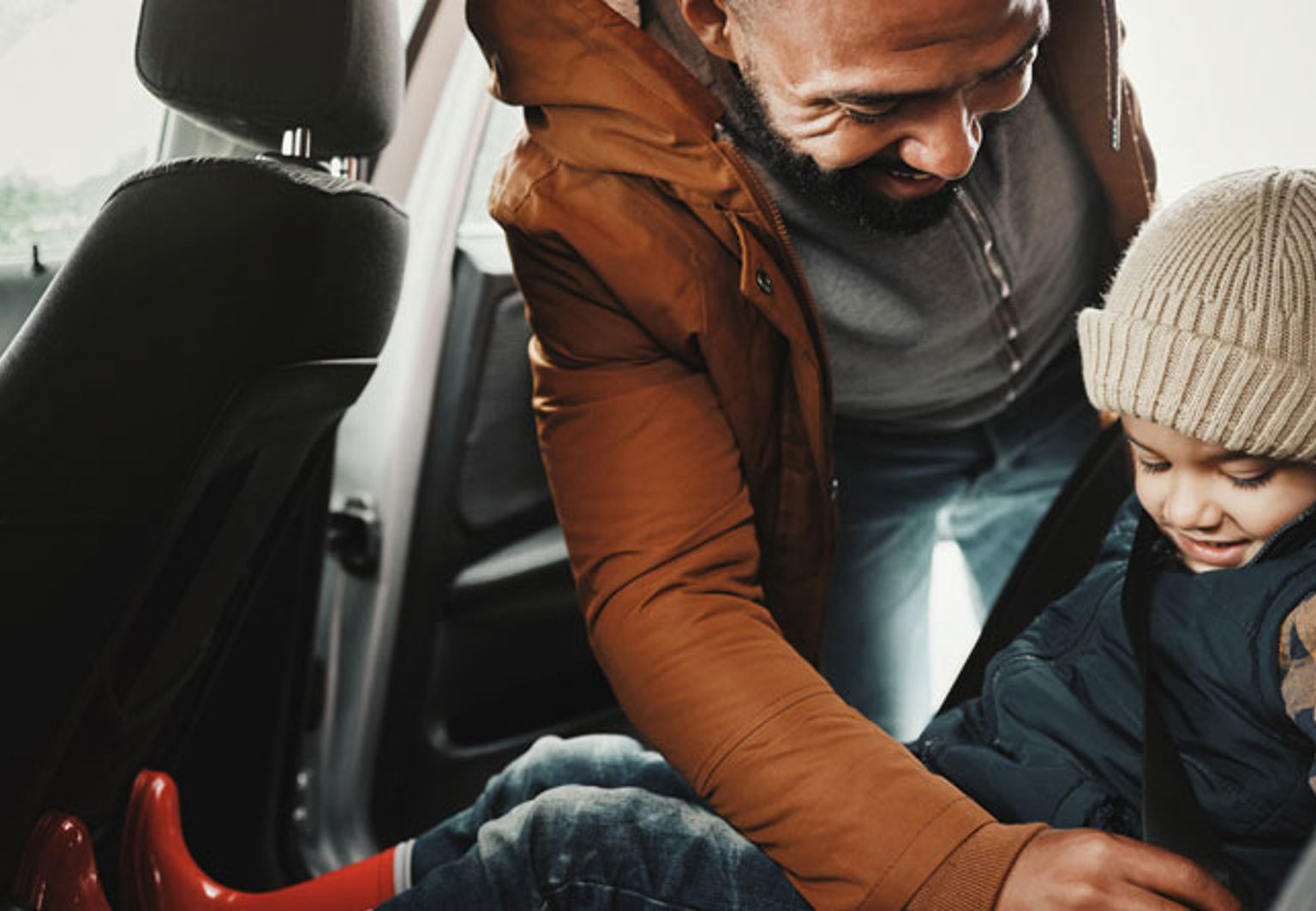 pappa hjälper sitt barn med säkerhetsbältet