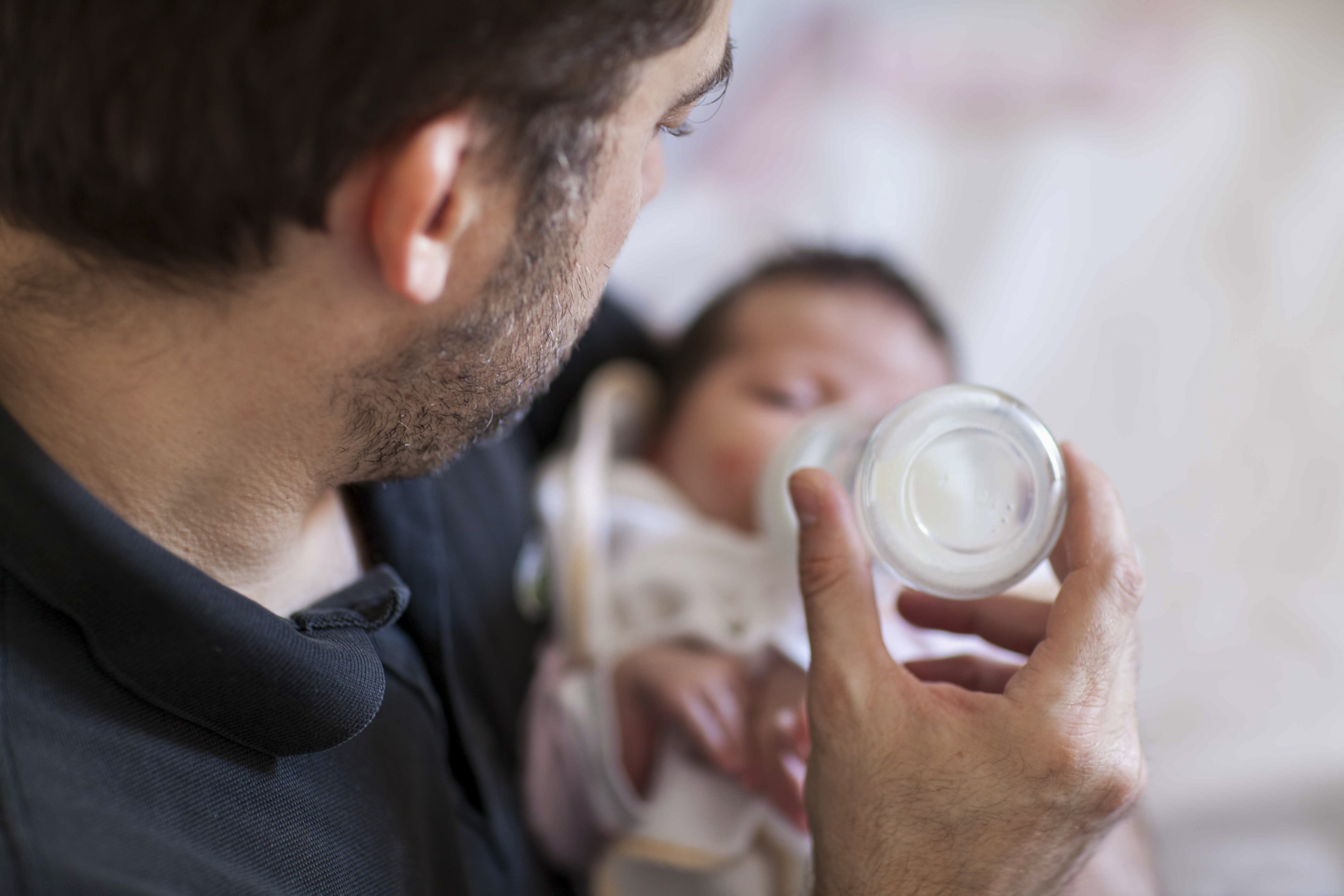 Pappa matar sin bebis med en nappflaska