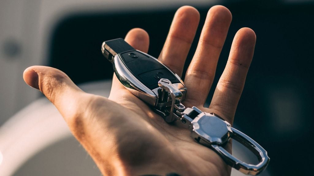 Hand som håller i en keyless-bilnyckel för nyckellöst system