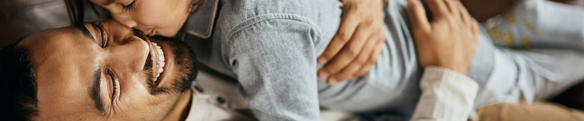 man med sitt barn som kramas